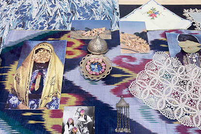 Alize Zorlutuna, An index of Inheritances, 2025, Variable materials, including El Isi (Anatolian lace), photographs, dried jasmine flowers, rose buds, olive leaves, eucalyptus leaves, rue, ikat silk, copper plate, brass bowl, perfume bottle, jar with honey and almonds, nazar (evil eye) bead. 